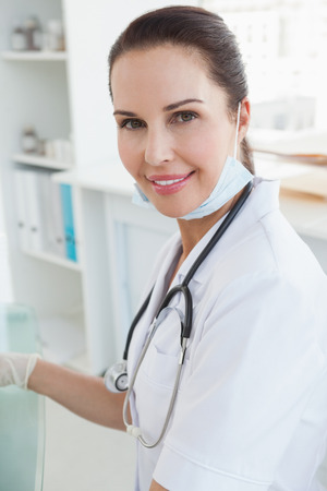 Smiling doctor in her office looking at the cameraの写真素材