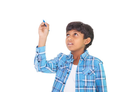 Cute boy smiling and writing on white background