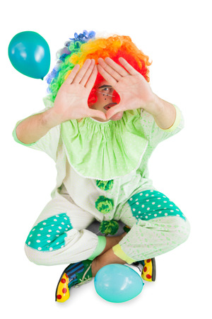 Funny clown framing with hands on white backgroundの写真素材