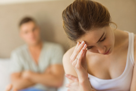 Upset couple not talking to each other after fight at home in the bedroomの写真素材