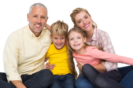 Happy family smiling at camera on white background