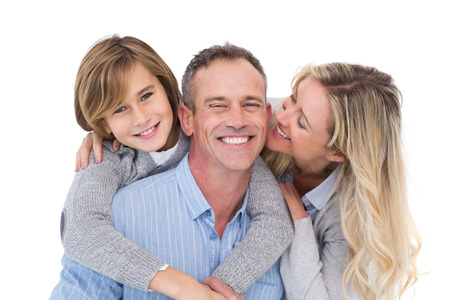 Happy father carrying his son and his wife on his back on white backgroundの写真素材