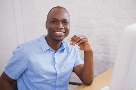 Portrait of a businessman smiling at camera in the officeの写真素材