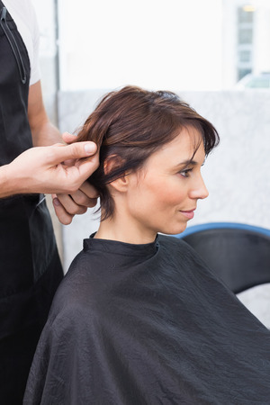 Pretty brunette at her hair appointment at the hair salonの写真素材