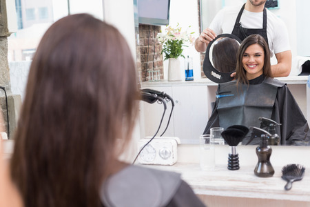 Pretty brunette happy with her haircut at the hair salonの写真素材