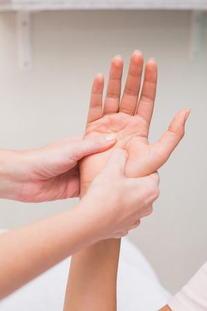Woman getting a hand massage at the beauty salonの写真素材