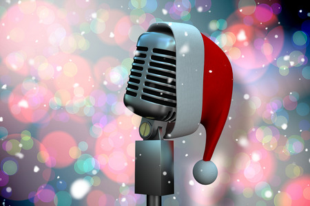 Composite image of microphone with santa hat against light glowing dots on blueの写真素材