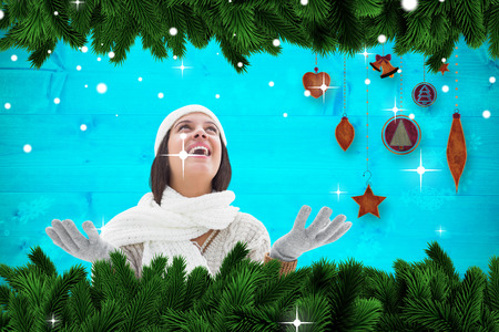 Brunette in warm clothing against  christmas themed frameの写真素材