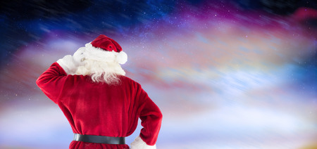Santa Claus against aurora night sky in purpleの写真素材