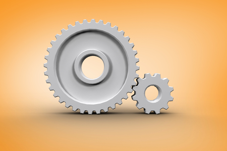 Composite image of White cog and wheel connecting against orange vignetteの写真素材