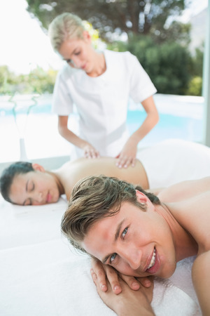Side view of a young couple enjoying massage at health farmの写真素材