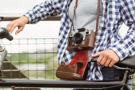 Close up of a retro camera around the neck of the girl in the parkの写真素材
