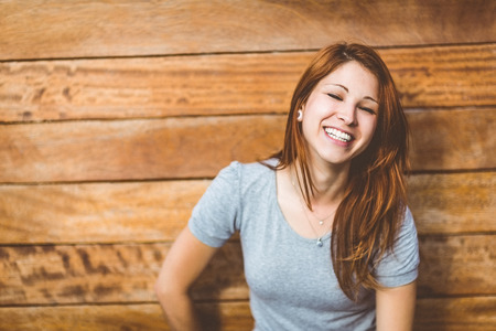 Portrait of a cheerful pretty redhead laughing in the cityの写真素材