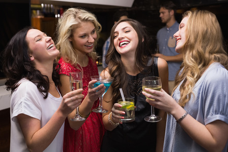 Pretty friends having a drink together at the bar
