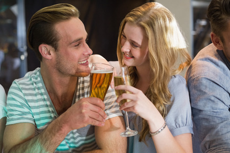 Happy friends having a drink together at the barの写真素材