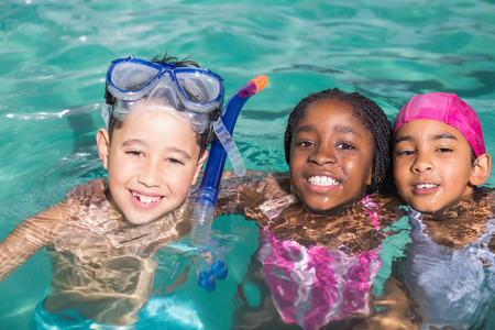 Cute little kids swimming in the pool at the leisure centerの写真素材