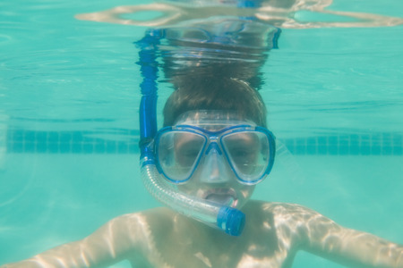Cute kid posing underwater in pool at the leisure centerの写真素材