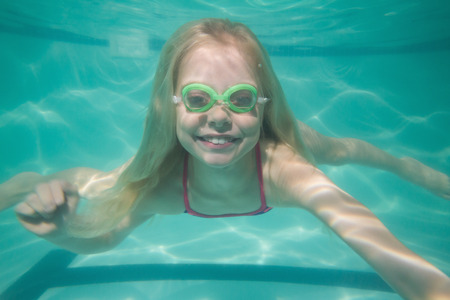 Cute kid posing underwater in pool at the leisure centerの写真素材