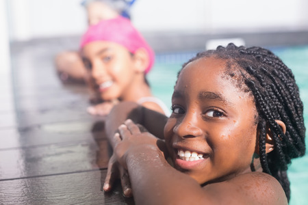 Cute little kids swimming in the pool at the leisure centerの写真素材