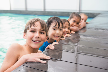 Cute swimming class in the pool at the leisure centerの写真素材