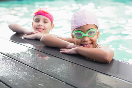 Cute little girls in the swimming pool at the leisure centerの写真素材