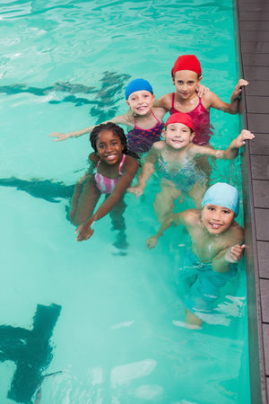 Cute little kids in the swimming pool at the leisure centerの写真素材