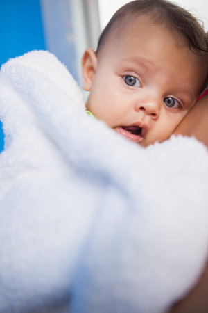 Cute baby wrapped in towel at the leisure centerの写真素材