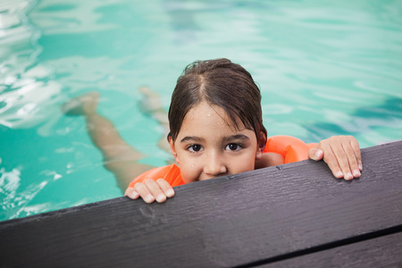 Little boy smiling in the pool at the leisure centerの写真素材