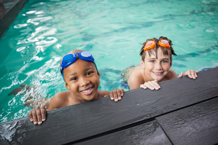 Little boys smiling in the pool at the leisure centerの写真素材