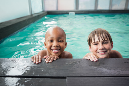 Little boys smiling in the pool at the leisure centerの写真素材