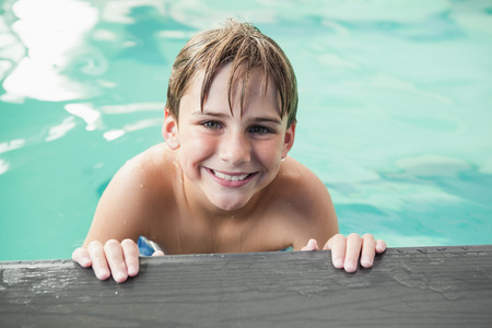 Little boy smiling in the pool at the leisure centerの写真素材