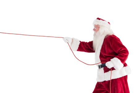 Santa pulls something with a rope on white backgroundの写真素材