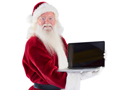 Santa Claus presents a laptop on white backgroundの写真素材