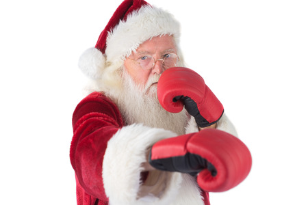 Santa Claus punches with his right on white backgroundの写真素材