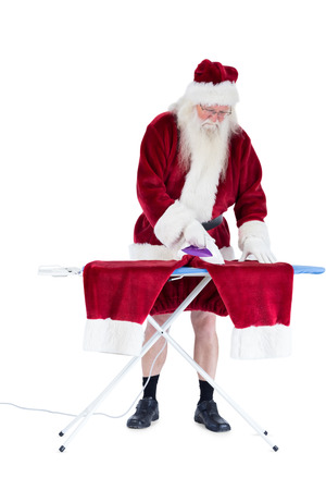 Santa is ironing his pants on white backgroundの写真素材