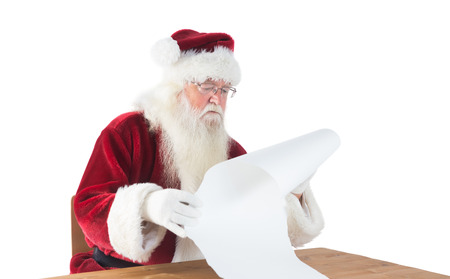 Santa reads a long list on white backgroundの写真素材