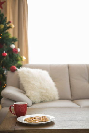 Cookies and mug on coffee table at christmas at home in the living roomの写真素材