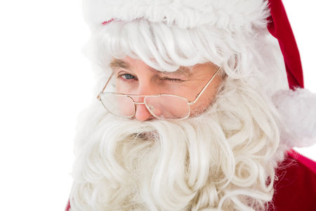 Portrait of santa claus winking on white backgroundの写真素材