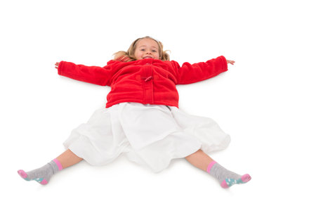 Cute little girl lying on floor on white backgroundの写真素材
