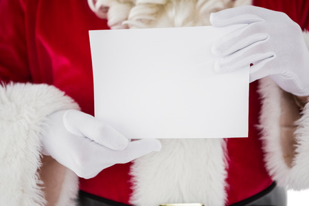 Mid section of santa holding card on white backgroundの写真素材