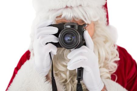 Portrait of santa taking a photo on white backgroundの写真素材