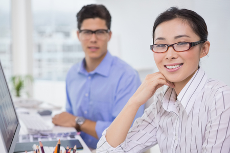 Creative team working at desk in creative officeの写真素材