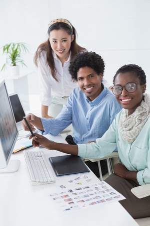 Creative team working at desk in creative officeの写真素材