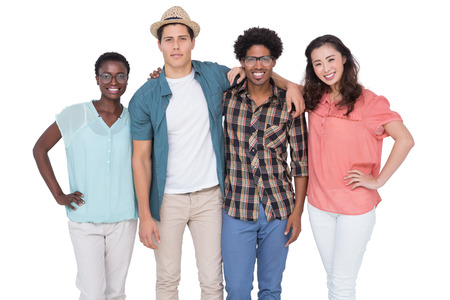 Stylish friends smiling at camera together on white background