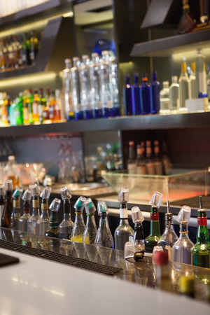 Close up on bar with bottle in a line at the nightclubの写真素材