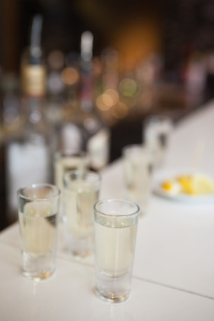 Close up of cocktail into shot glasses in a barの写真素材