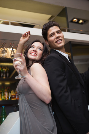 Happy friends dancing and smiling at the nightclubの写真素材