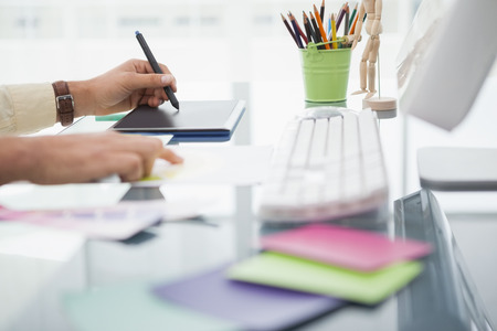 Designer working at desk using digitizer in his office