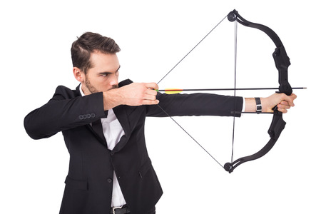 Elegant businessman shooting bow and arrow on white backgroundの写真素材