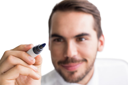 Portrait of happy businessman writing with marker on white backgroundの写真素材